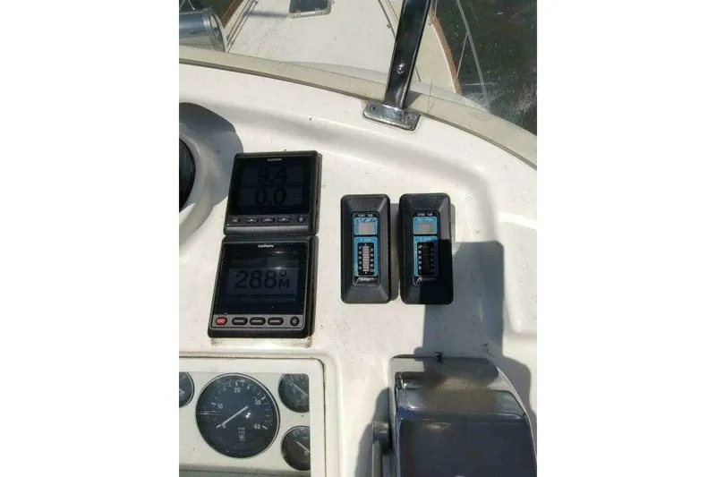 Slide: The Image of 1996 Grand Banks Eastbay 40 Flybridge dashboard with navigation instruments and gauges. - 22