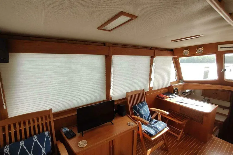 Slide: The Image of Interior of 1996 Grand Banks Eastbay 40 Flybridge with wooden furnishings and nautical decor. - 46