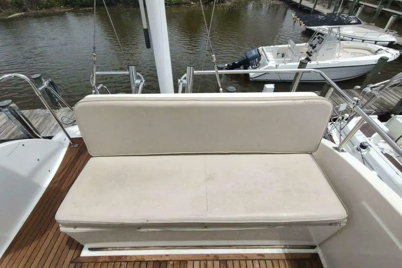 Slide: The Image of Grand Banks Eastbay 40 Flybridge 1996, featuring a cushioned bench on teak deck. - 17