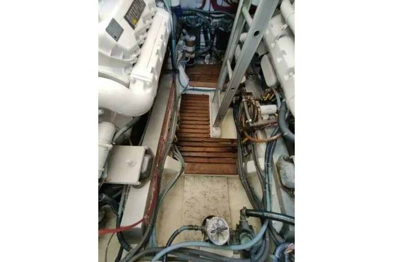 Slide: The Image of Engine room of 1996 Grand Banks Eastbay 40 Flybridge with visible machinery and components. - 77
