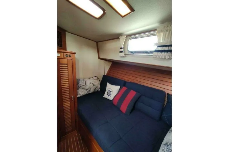 Slide: The Image of Cozy cabin interior of 1996 Grand Banks Eastbay 40 Flybridge with nautical-themed decor. - 61