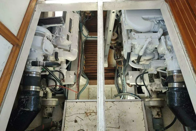 Slide: The Image of Engine room of 1996 Grand Banks Eastbay 40 Flybridge with dual engines and mechanical components. - 74