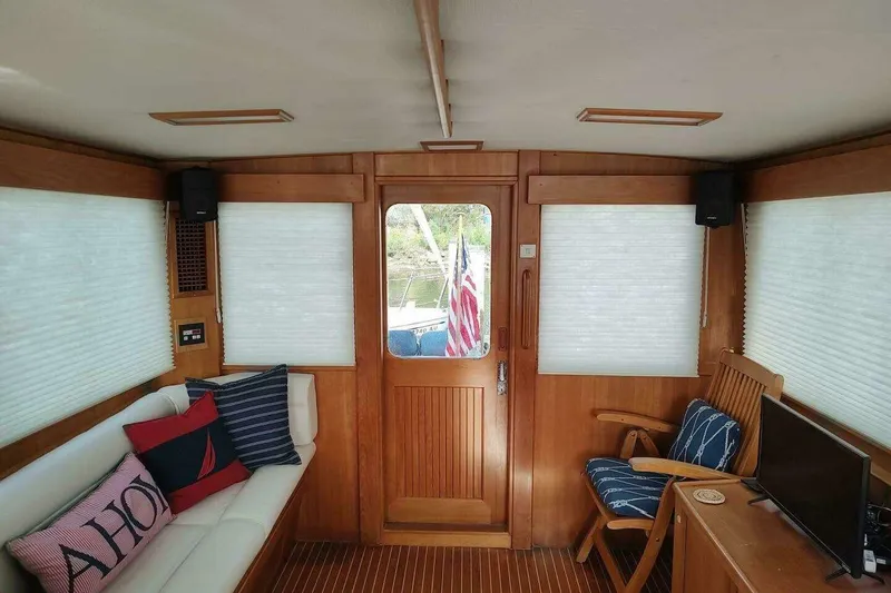 Slide: The Image of Interior of 1996 Grand Banks Eastbay 40 Flybridge with cozy seating and wooden decor. - 42