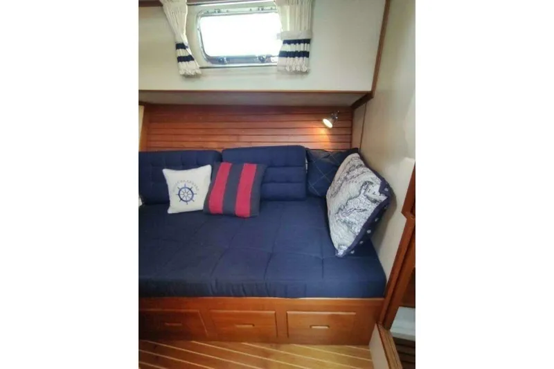 Slide: The Image of Cozy cabin interior of 1996 Grand Banks Eastbay 40 Flybridge with nautical-themed cushions. - 62