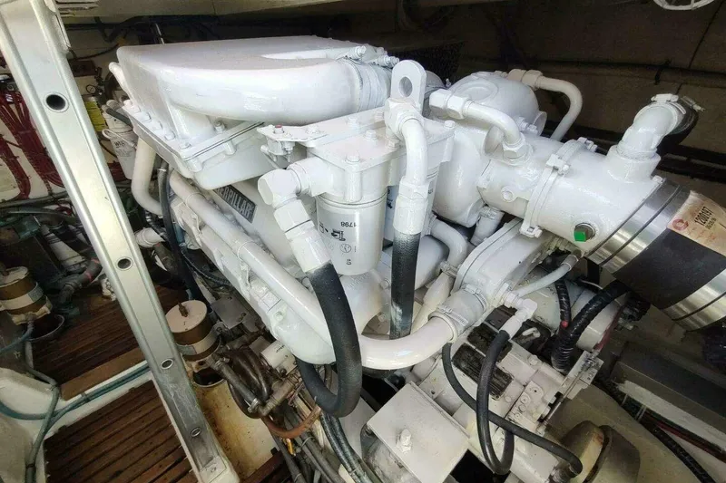 Slide: The Image of Engine room of 1996 Grand Banks Eastbay 40 Flybridge, showcasing detailed machinery components. - 83