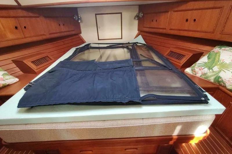 Slide: The Image of Interior cabin of 1996 Grand Banks Eastbay 40 Flybridge with wooden cabinetry and bedding. - 71