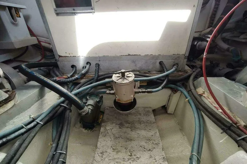 Slide: The Image of Engine room of 1996 Grand Banks Eastbay 40 Flybridge with visible hoses and components. - 92