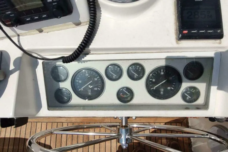Slide: The Image of 1996 Grand Banks Eastbay 40 Flybridge dashboard with gauges and controls. - 21