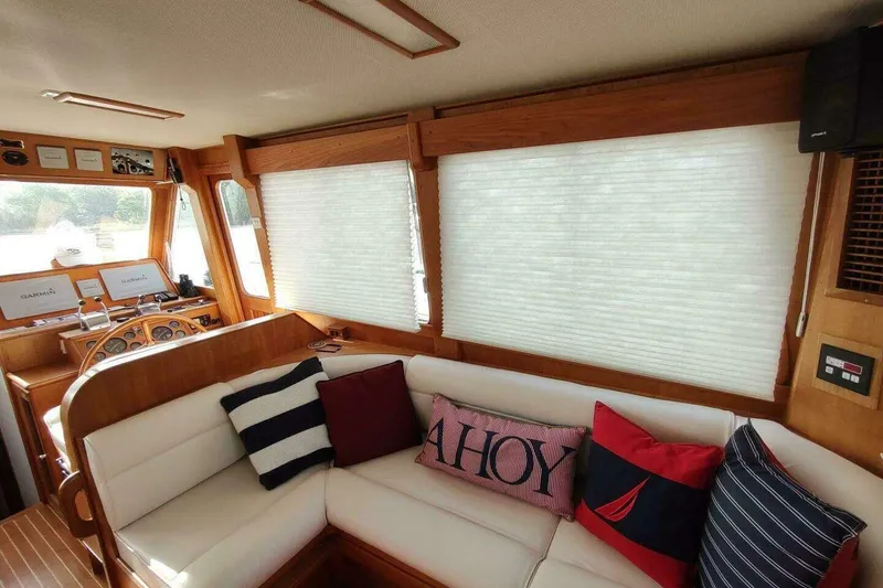 Slide: The Image of Cozy interior of 1996 Grand Banks Eastbay 40 Flybridge with nautical-themed cushions. - 40