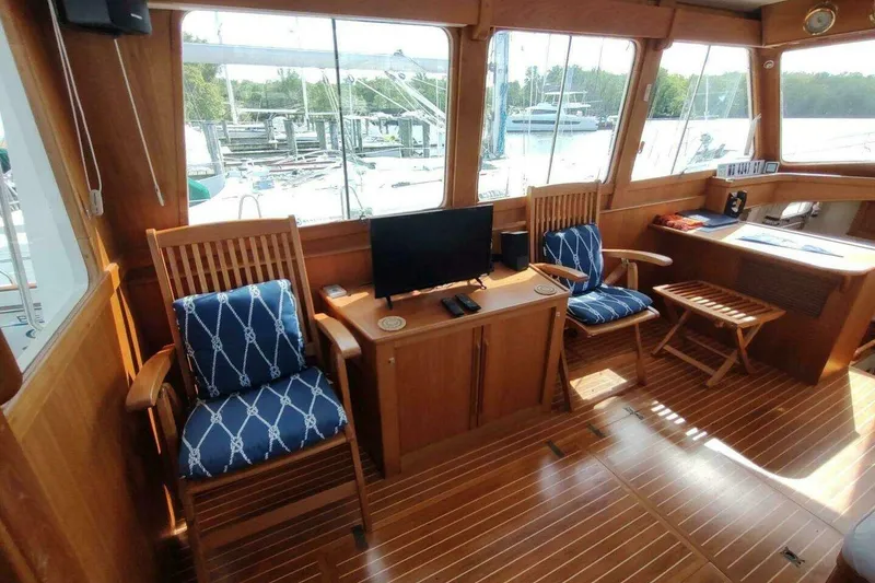 Slide: The Image of Interior of 1996 Grand Banks Eastbay 40 Flybridge with wooden decor and nautical seating. - 44