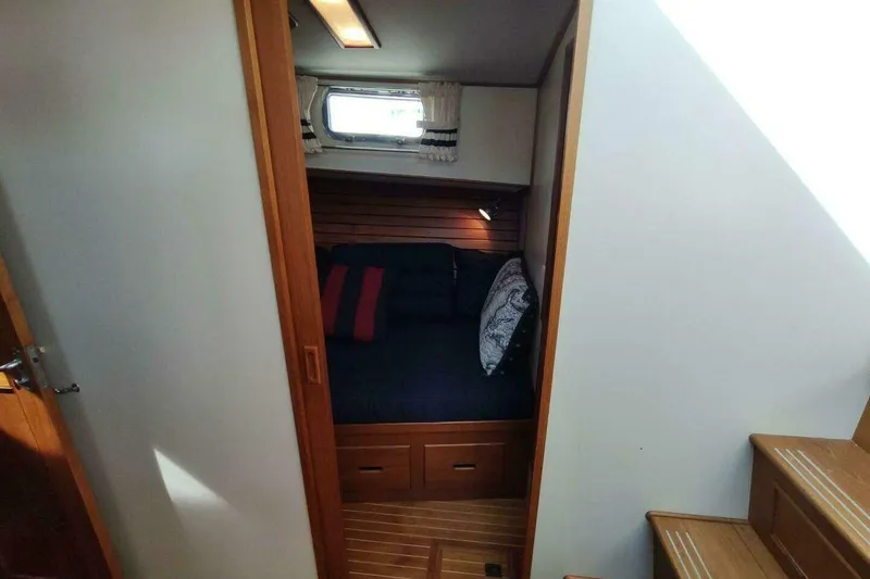 Slide: The Image of Cozy cabin interior of 1996 Grand Banks Eastbay 40 Flybridge with wooden accents and bedding. - 59