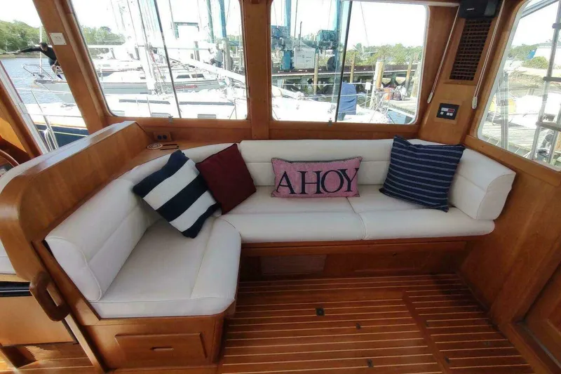Slide: The Image of Interior of 1996 Grand Banks Eastbay 40 Flybridge with cozy seating and nautical pillows. - 39