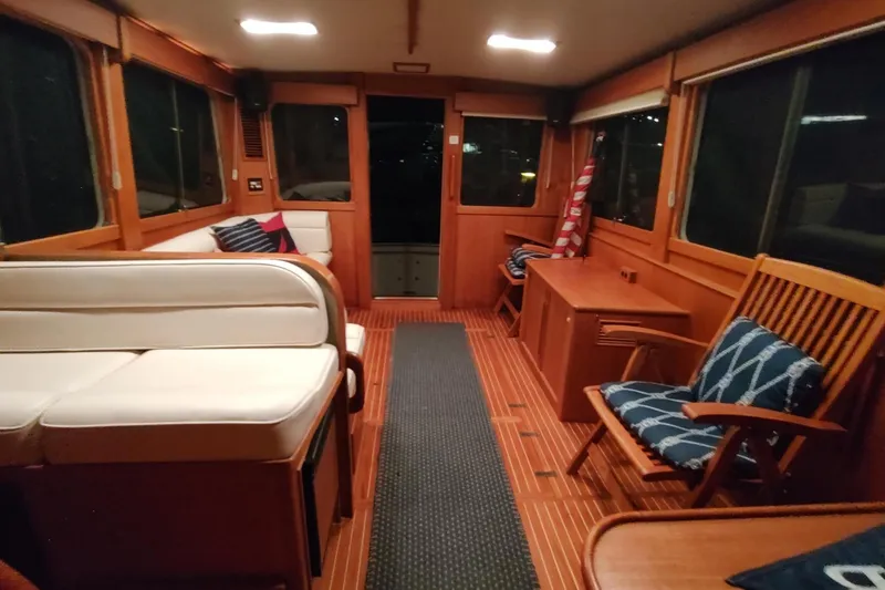 Slide: The Image of Interior of 1996 Grand Banks Eastbay 40 Flybridge with wooden furnishings and seating. - 24