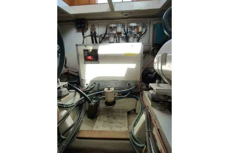 Slide: The Image of Engine room of 1996 Grand Banks Eastbay 40 Flybridge with visible machinery and cables. - 86