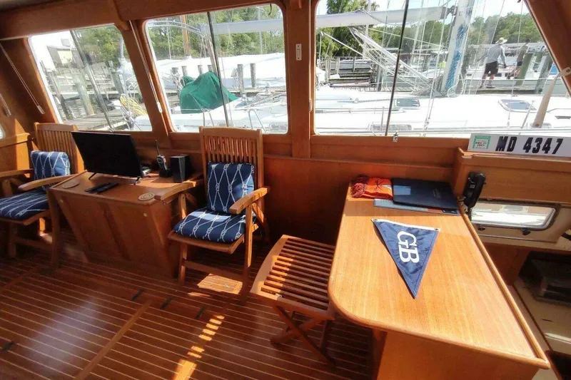 Slide: The Image of Interior of 1996 Grand Banks Eastbay 40 Flybridge with wooden furnishings and nautical decor. - 47