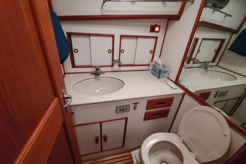 Slide: The Image of Bathroom interior of 1996 Grand Banks Eastbay 40 Flybridge yacht, featuring sink and toilet. - 72