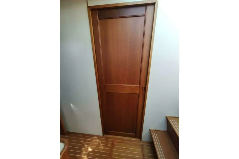 Slide: The Image of Wooden interior door and stairs on 1996 Grand Banks Eastbay 40 Flybridge yacht. - 58