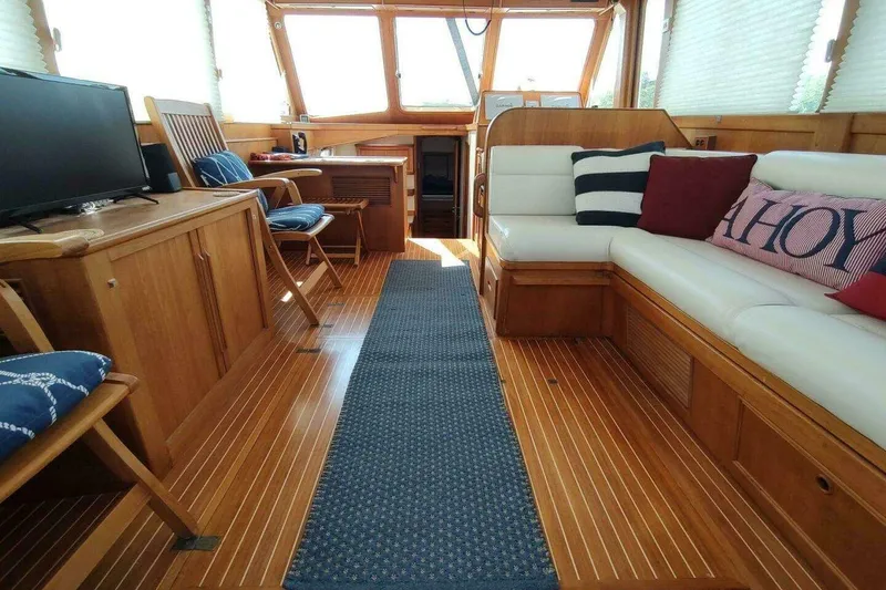Slide: The Image of Luxurious 1996 Grand Banks Eastbay 40 Flybridge interior with wooden flooring and cozy seating. - 43