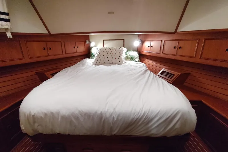 Slide: The Image of Cozy cabin interior of 1996 Grand Banks Eastbay 40 Flybridge with wooden cabinetry and bed. - 65