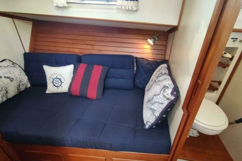 Slide: The Image of Cozy cabin interior of 1996 Grand Banks Eastbay 40 Flybridge with nautical-themed cushions. - 63
