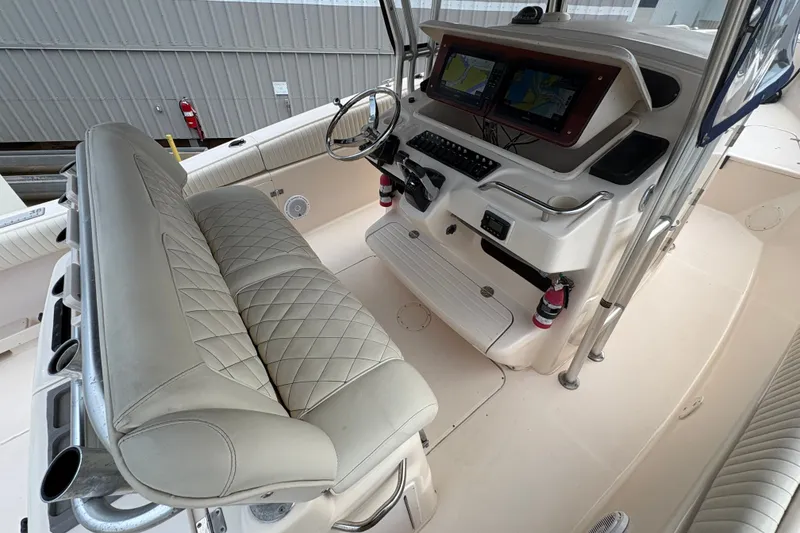 Slide: The Image of 2004 Grady White Bimini 306 boat interior with steering console and seating. - 16