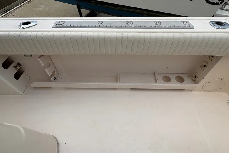 Slide: The Image of 2004 Grady White Bimini 306 boat interior with measuring ruler and storage compartments. - 20