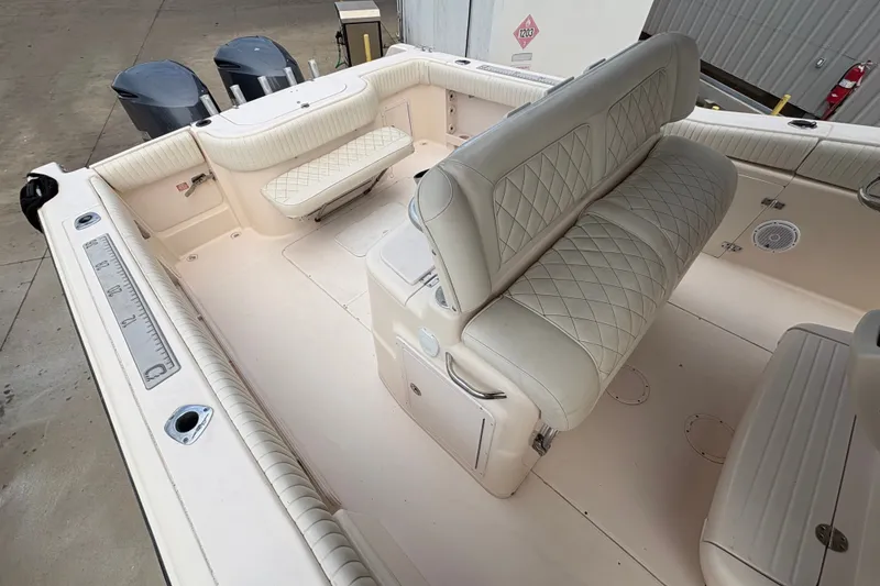Slide: The Image of 2004 Grady White Bimini 306 boat interior with cushioned seating and fishing rod holders. - 15