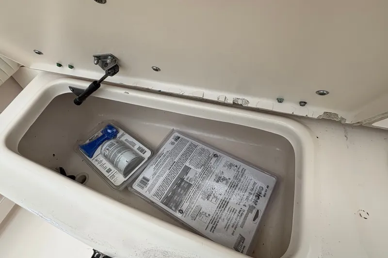 Slide: The Image of Storage compartment on a 2004 Grady White Bimini 306 boat with safety equipment. - 23