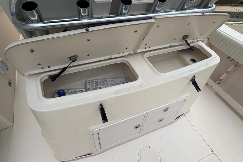 Slide: The Image of Open storage compartments on a 2004 Grady White Bimini 306 boat deck. - 21