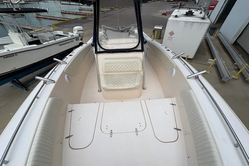 Slide: The Image of 2004 Grady White Bimini 306 boat interior at dock, showcasing seating and storage. - 14