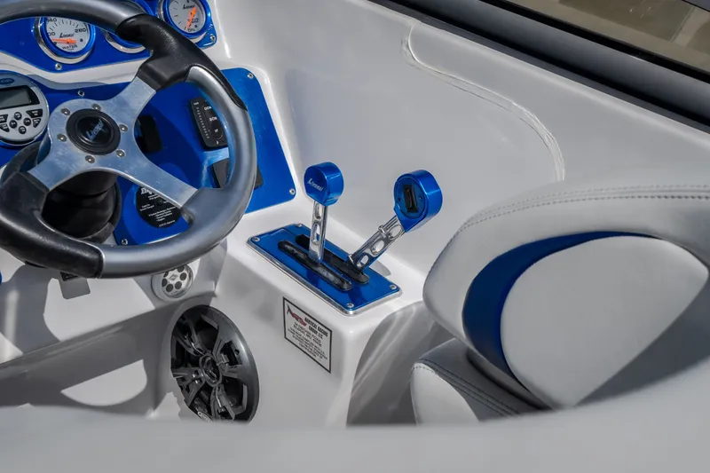 Slide: The Image of Interior of 2012 Nautical NRG 30 boat with steering wheel and control levers. - 14