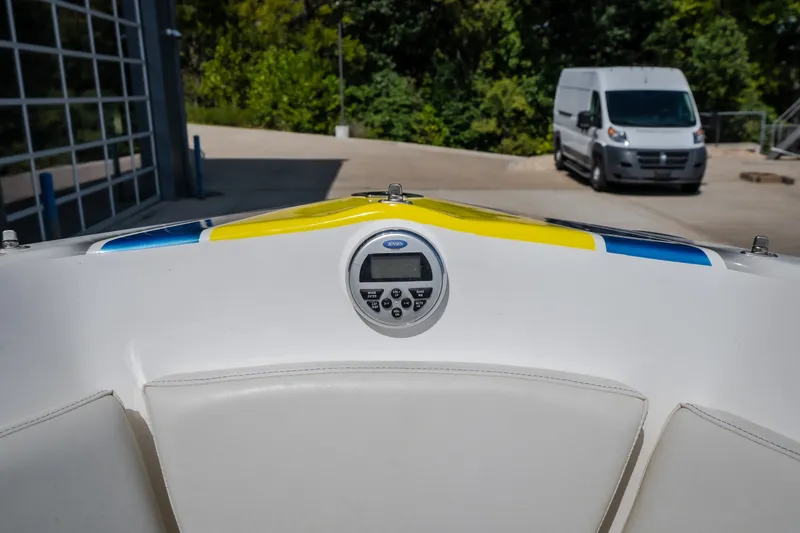 Slide: The Image of Nautical NRG 30 boat dashboard with colorful accents, parked near a white van. - 25