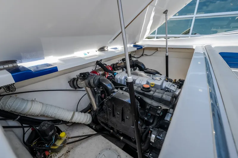 Slide: The Image of Engine compartment of a 2012 Nautical NRG 30 boat, showcasing mechanical components. - 22
