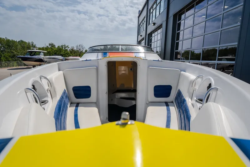 Slide: The Image of 2012 Nautical NRG 30 boat interior with white and blue seating, docked near a modern building. - 42