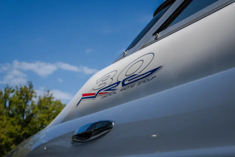 Slide: The Image of Nautical NRG 30 boat, 2012 model, with logo against blue sky background. - 57