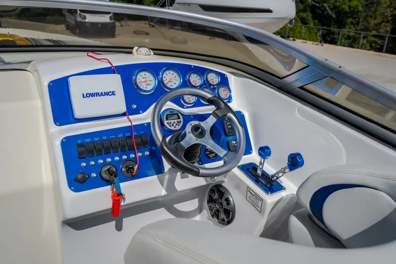 Slide: The Image of Cockpit of 2012 Nautical NRG 30 boat with steering wheel and control panel. - 13