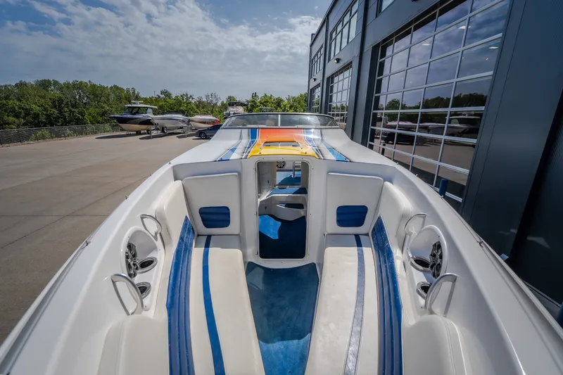 Slide: The Image of Nautical NRG 30 boat, 2012 model, docked near a modern building under a clear sky. - 28