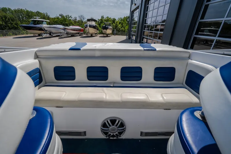 Slide: The Image of Interior of a 2012 Nautical NRG 30 boat with blue and white seating. - 19
