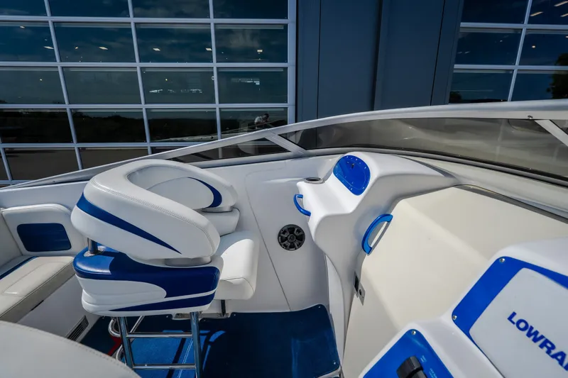 Slide: The Image of Interior of a 2012 Nautical NRG 30 boat with blue and white seating. - 17