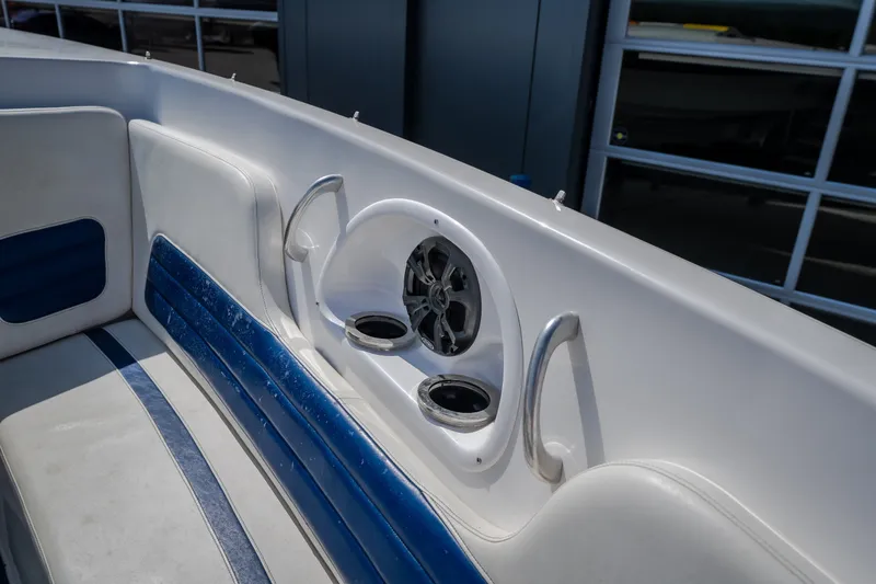 Slide: The Image of Interior of 2012 Nautical NRG 30 boat with blue and white seating and speaker system. - 33