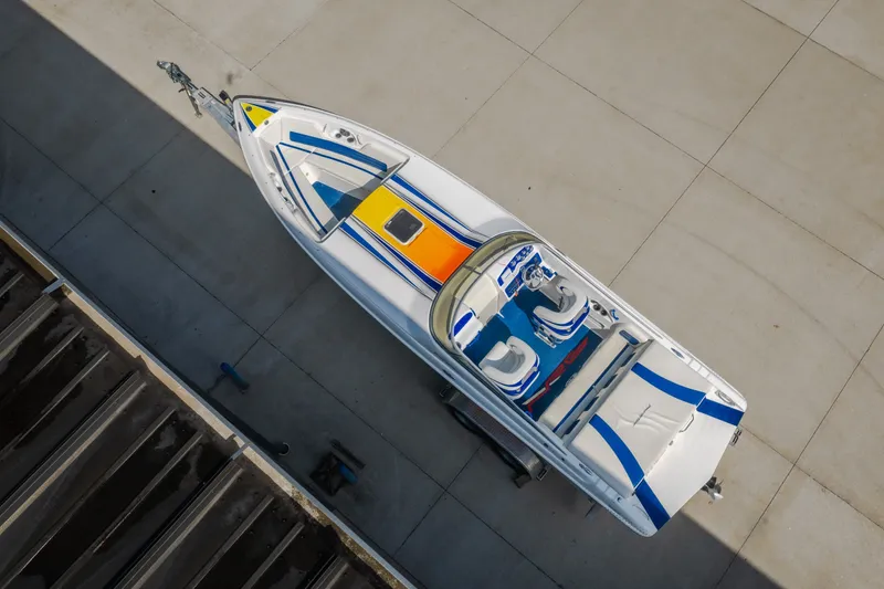 Slide: The Image of Aerial view of 2012 Nautical NRG 30 boat with colorful deck design. - 5