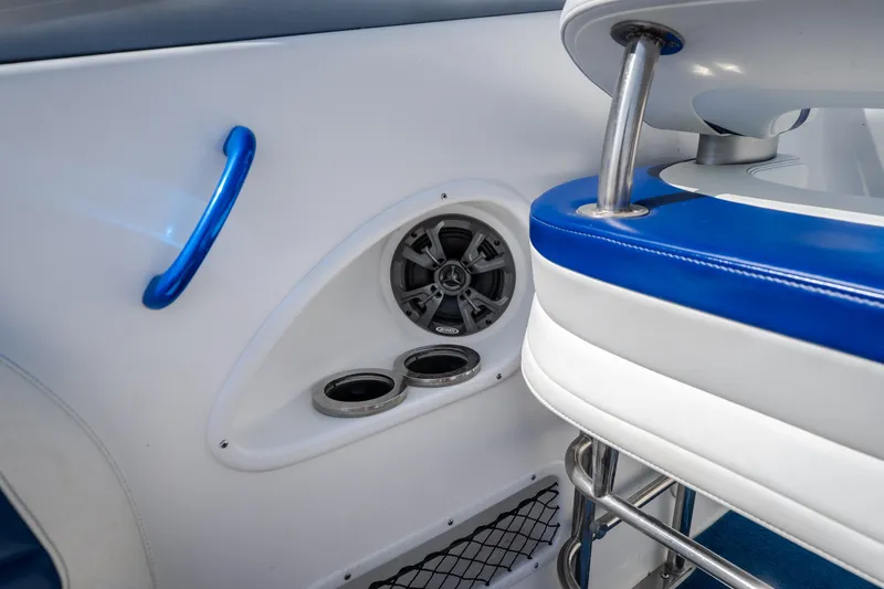 Slide: The Image of Interior of 2012 Nautical NRG 30 boat with blue accents and speaker system. - 37
