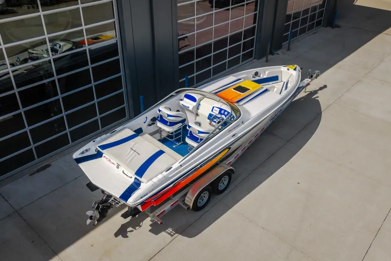Slide: The Image of Nautical NRG 30 speedboat, 2012 model, on trailer outside a garage. - 4