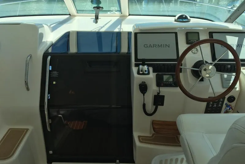 Slide: The Image of 2009 Tiara Yachts 3900 Sovran helm with Garmin navigation system and steering wheel. - 15