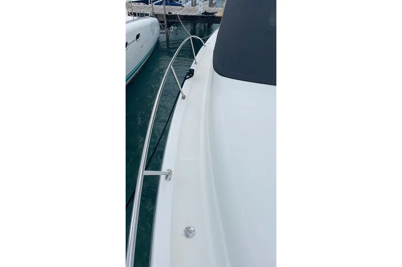 Slide: The Image of 2009 Tiara Yachts 3900 Sovran docked, showcasing sleek deck and railing design. - 24