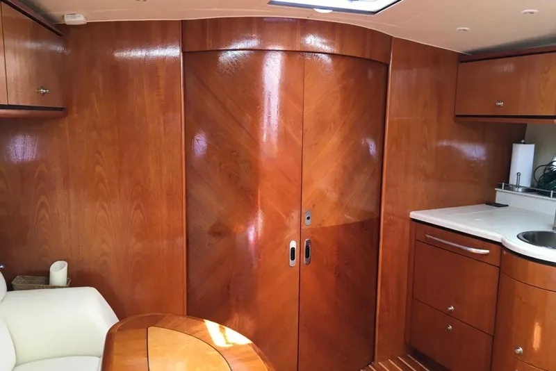 Slide: The Image of Interior of 2009 Tiara Yachts 3900 Sovran with polished wood cabinetry and modern amenities. - 13