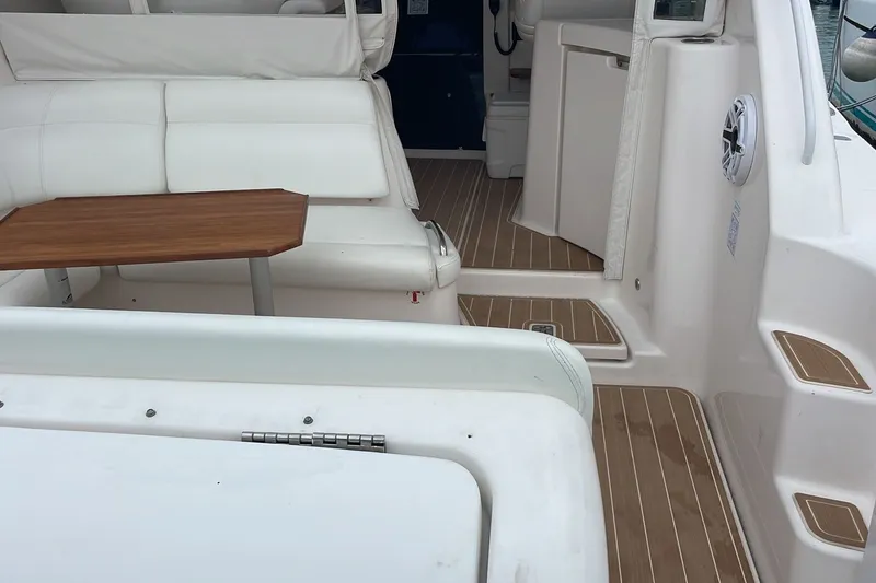 Slide: The Image of Interior of 2009 Tiara Yachts 3900 Sovran with white seating and wooden table. - 17