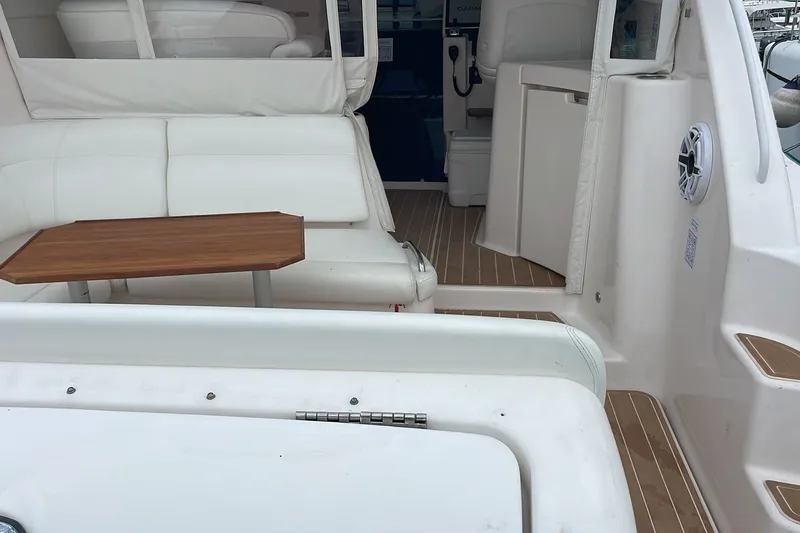 Slide: The Image of 2009 Tiara Yachts 3900 Sovran interior with white seating and wooden table. - 18
