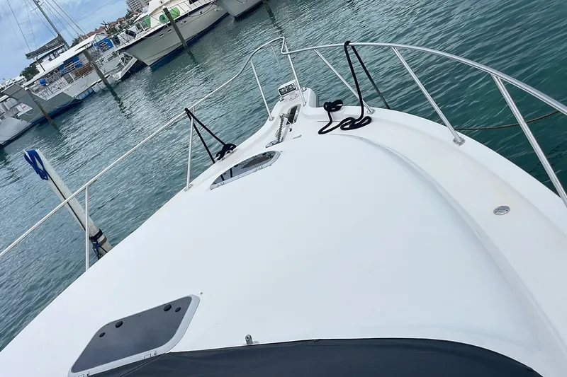 Slide: The Image of 2009 Tiara Yachts 3900 Sovran docked in a marina, showcasing sleek deck design. - 22