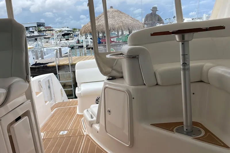 Slide: The Image of Interior view of 2009 Tiara Yachts 3900 Sovran, featuring elegant seating and marina backdrop. - 25